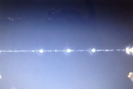  Photograph of 3 separate 400nm particles which have been successfully trapped above the waveguide. [2]